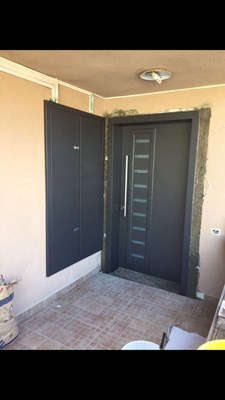 החלפת דלת כניסה הכולל ארון חשמל צמוד בגוון אפור מגורען נותן מראה של אחידות ושלמות כניסת הבית